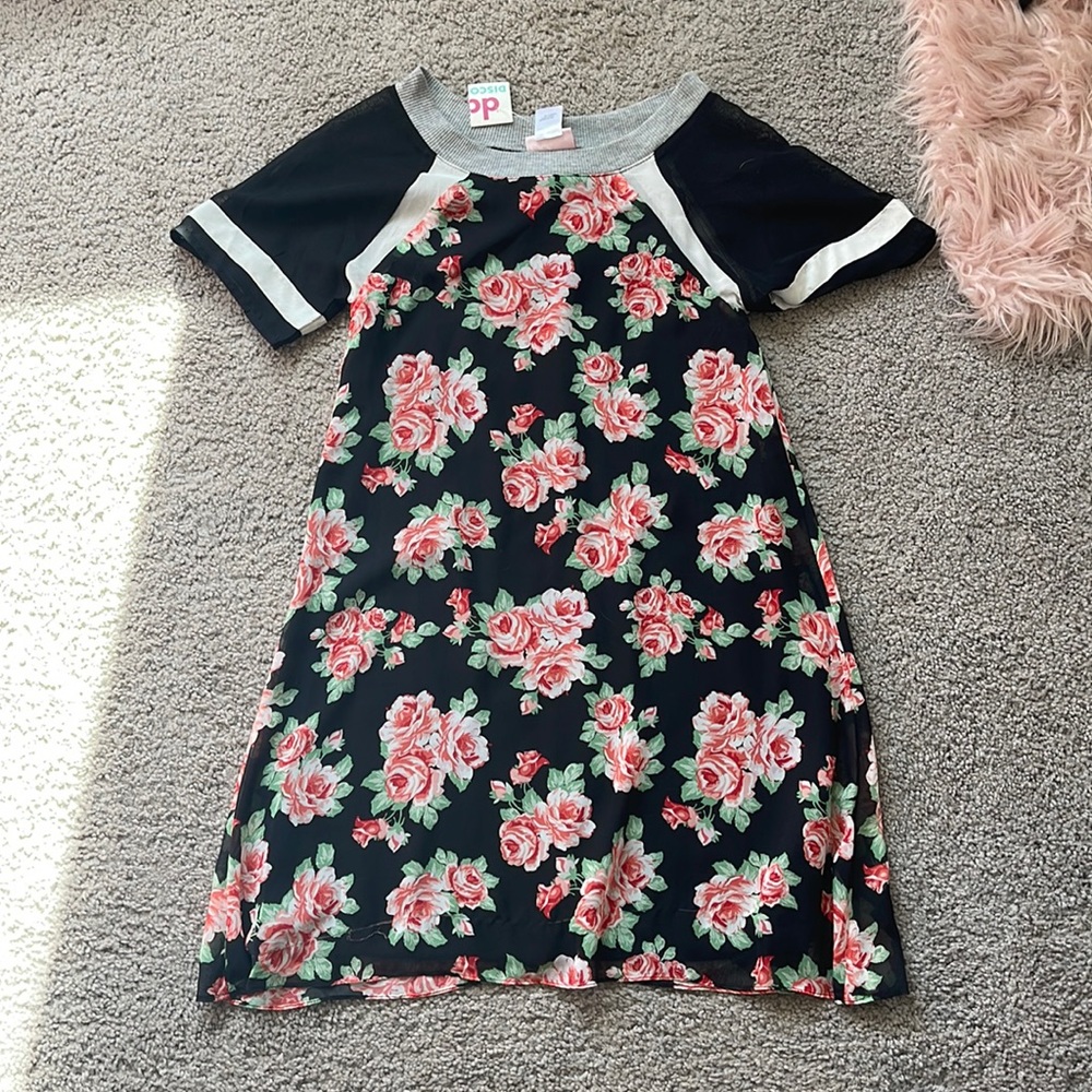 Lace material kind of dress, pretty small I would say for a a young girl